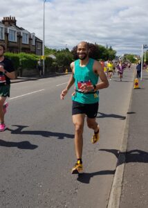 Jacob taking part in a race, running on a road